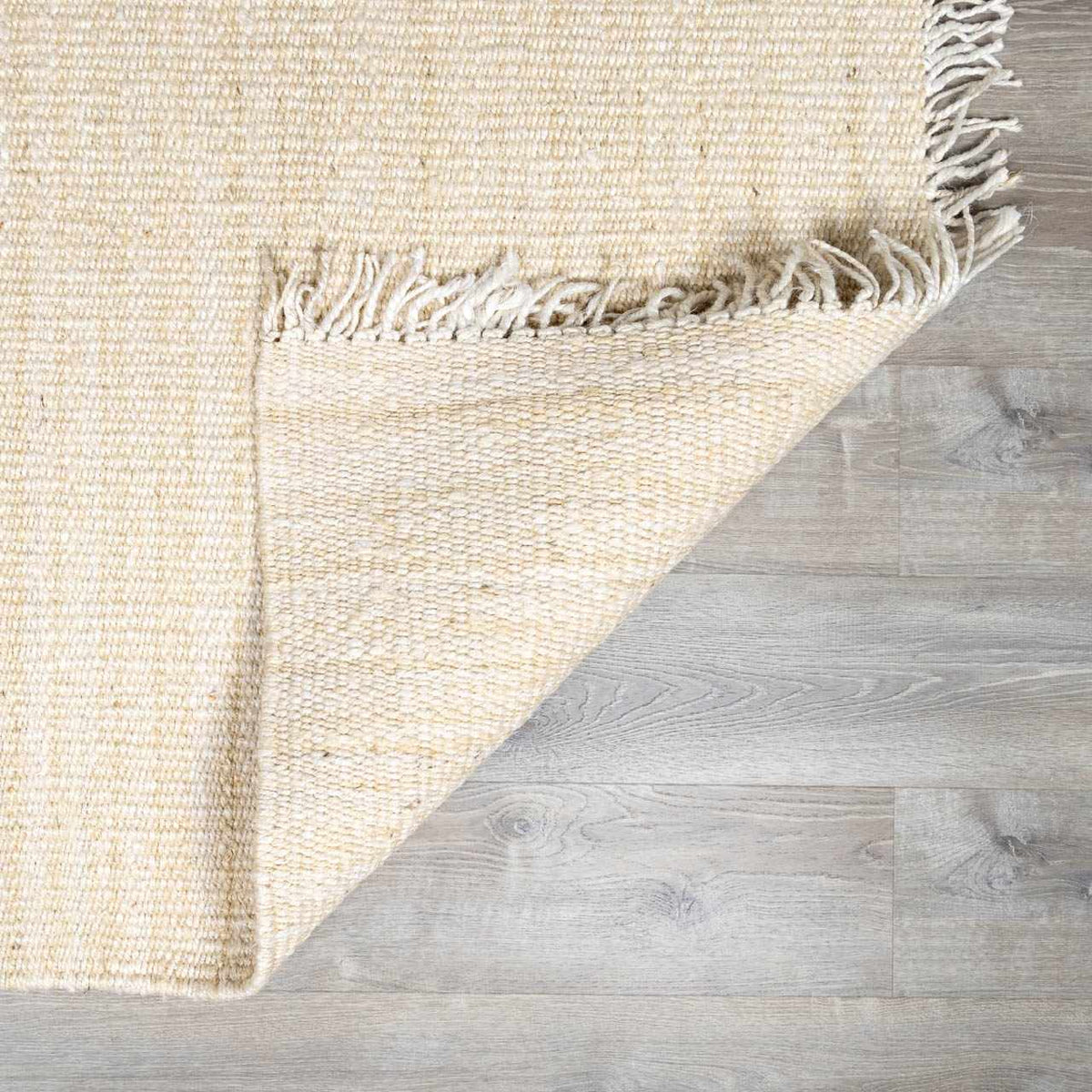 Iantha Handmade Ivory Jute Rug With Custom Shape And Fringe