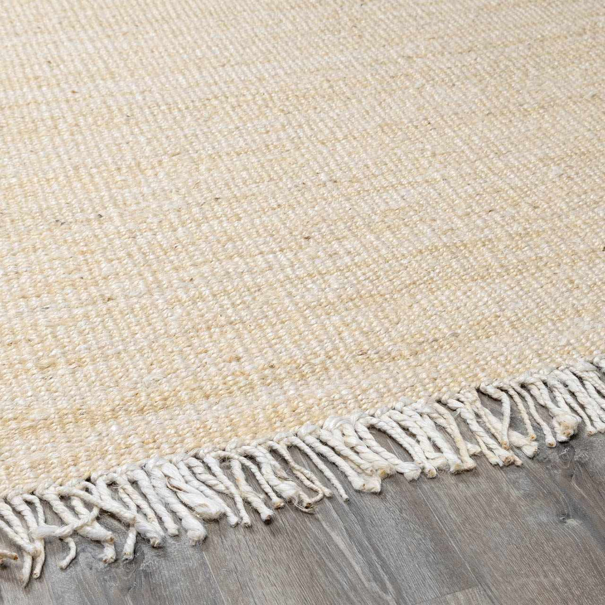 Iantha Handmade Ivory Jute Rug With Custom Shape And Fringe