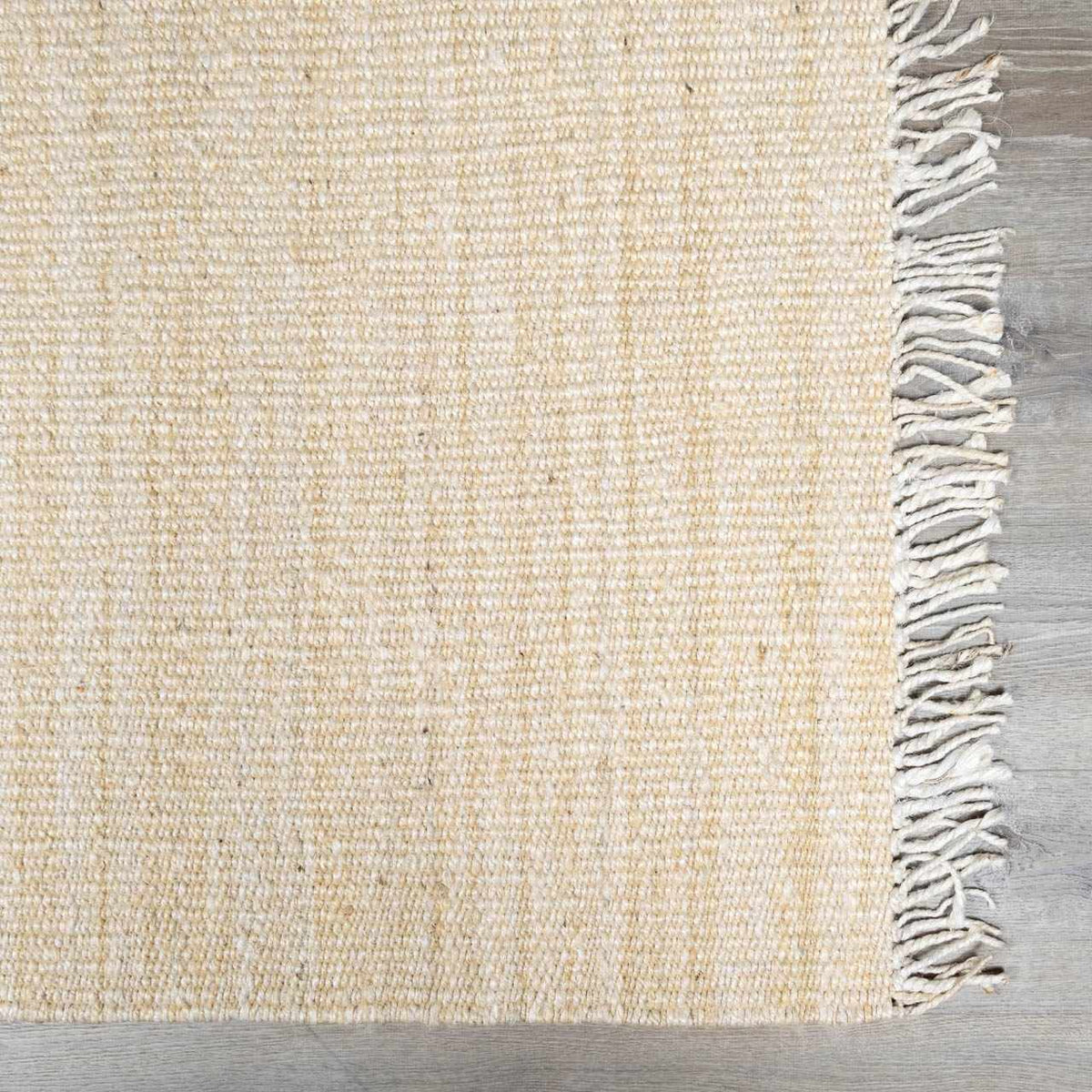 Iantha Handmade Ivory Jute Rug With Custom Shape And Fringe